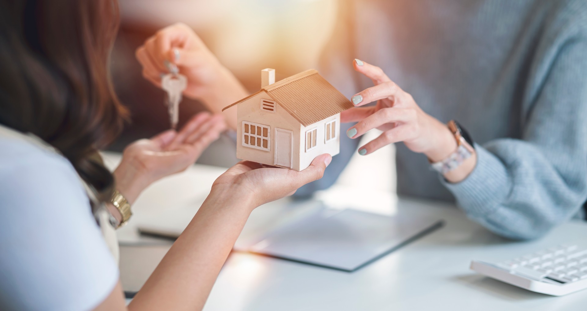 Close-up shot of a real estate agent or Real Estate Agent meeting with her client, giving new house to her customer.