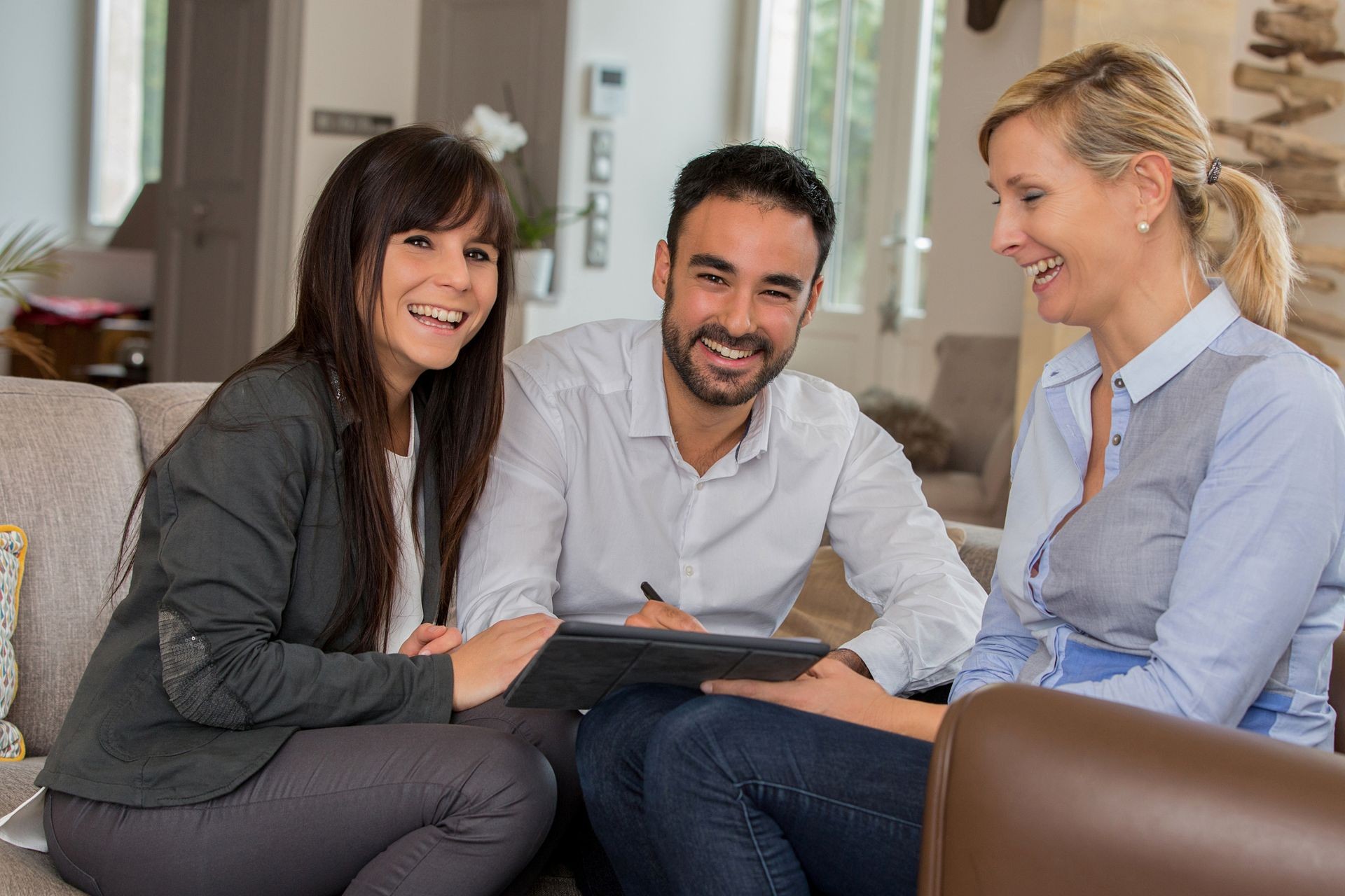 young couple signing contract with agent